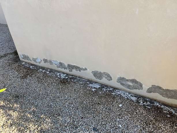 Sulfate Attack At Base Of Stuccoed Wall